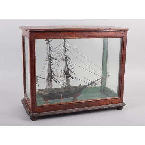 180 - An early 19th century model of a two-mast square-rigger, in an oak and four-glass case, 12 1/2