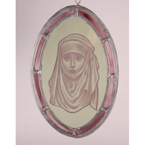 187 - An oval stained glass panel, 15th century woman in wimple, 10