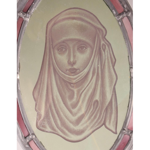 187 - An oval stained glass panel, 15th century woman in wimple, 10