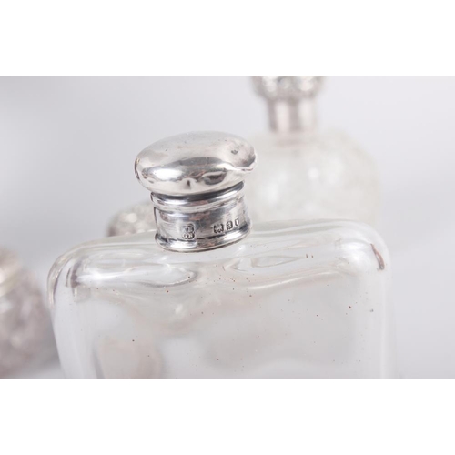 288 - A silver topped glass hip flask, a silver topped scent bottle, a silver topped dressing table jar, a... 