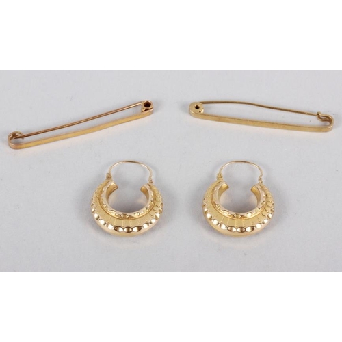 303 - A 9ct gold bar brooch, 1.9g, a bar brooch stamped 15ct, 2.8g, and a pair of 9ct gold hoop earrings, ... 