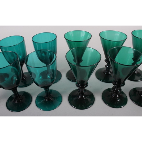 36 - A set of six 19th century green glass conical wines, an early 19th century green glass rum decanter ... 