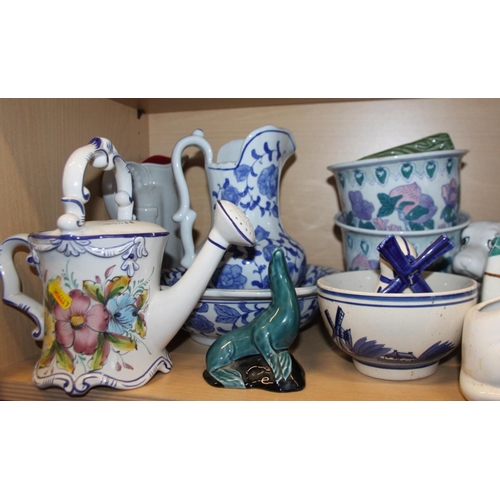 51 - A blue and white toilet jug and basin, a pair of planters, on stands, a floral decorated watering ca... 