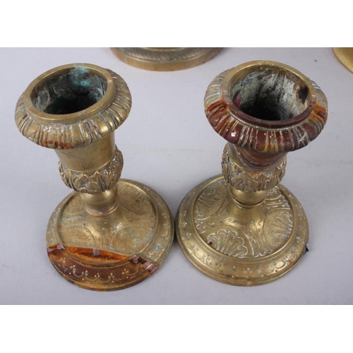 135 - A pair of brass candlesticks with acanthus leaf and scrolled decoration, 4 1/2