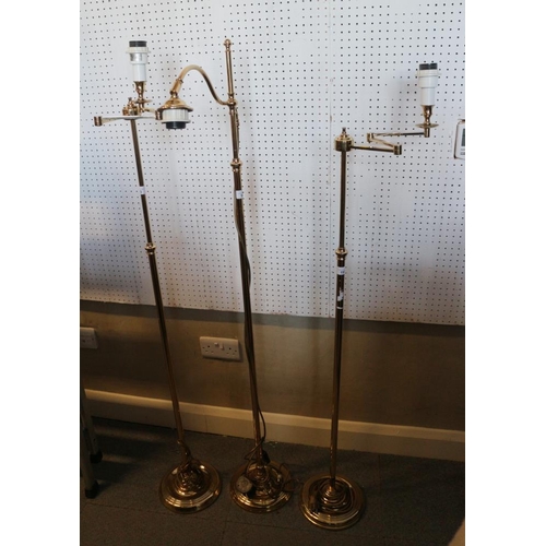 193 - A pair of gilt adjustable standard lamps, 57