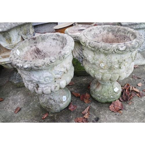 594 - A pair of stone pedestal planters, decorated flowers and swags, 18