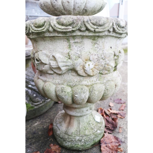 594 - A pair of stone pedestal planters, decorated flowers and swags, 18