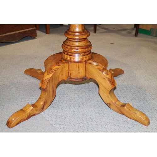 305 - A 19th century Italian walnut octagonal parquetry top low occasional table, on turned column and qua... 