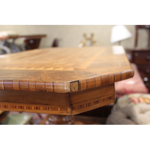 305 - A 19th century Italian walnut octagonal parquetry top low occasional table, on turned column and qua... 