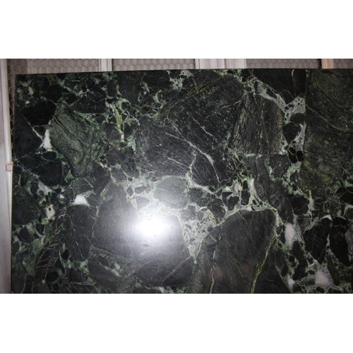 405 - A green marble top dining table, on faux carved stone supports, top 68