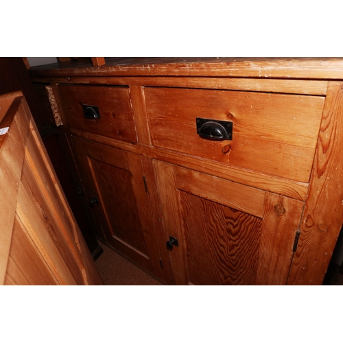 416 - A waxed pine dresser with open shelves over three drawers and three cupboards, on block base, 62