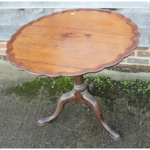 317 - A provincial oak circular tilt top occasional table, on baluster turned column and tripod splay supp... 