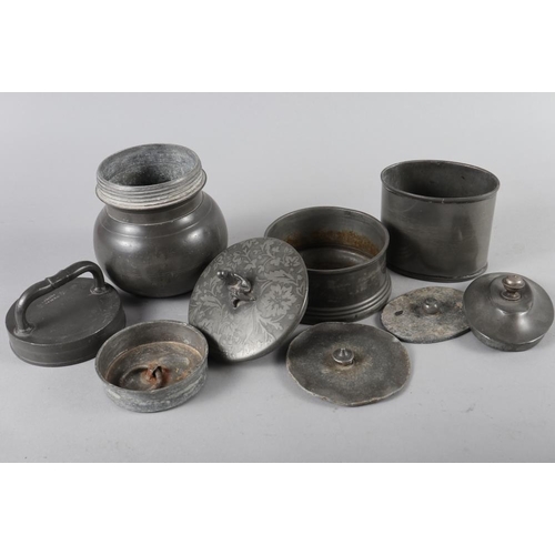 103 - Two pewter tobacco jars and covers with weights, a French tobacco jar and cover, two pewter egg cups... 