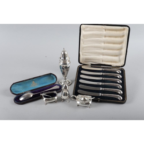 205 - A silver mustard three piece cruet, a cased spoon, 4.8oz troy approx, a weighted silver sugar shaker... 