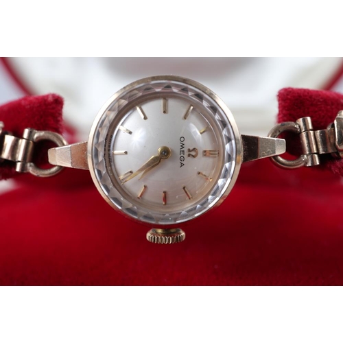 223 - A lady's Omega 9ct gold cased wristwatch with silvered dial and baton numerals, on 9ct gold bracelet... 