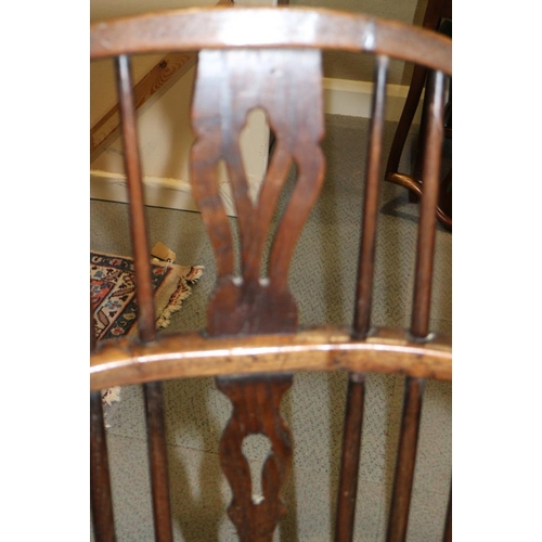 338 - An early 19th century ash and elm panel Windsor splat back elbow chair, on turned supports with crin... 