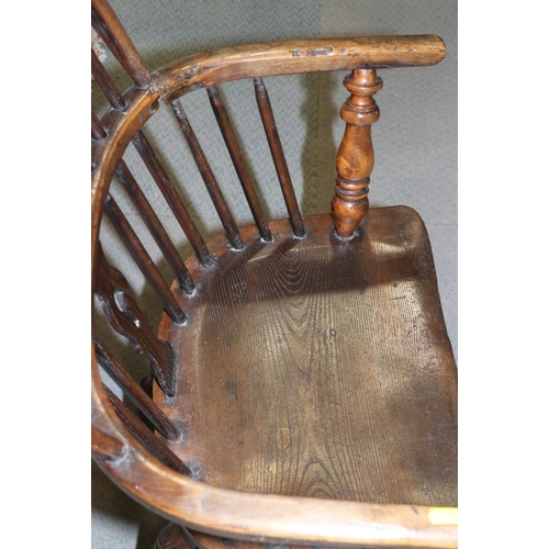 338 - An early 19th century ash and elm panel Windsor splat back elbow chair, on turned supports with crin... 