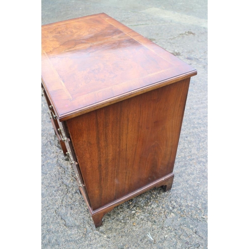 380 - A figured walnut and banded kneehole desk of George I design, fitted one long drawer over six small ... 