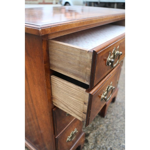 380 - A figured walnut and banded kneehole desk of George I design, fitted one long drawer over six small ... 