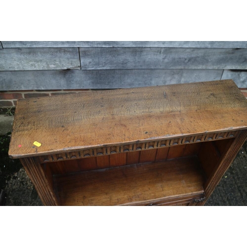 382 - A carved oak open bookcase over cupboard enclosed two doors, on stile supports, 33