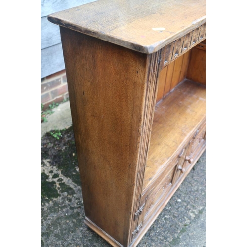 382 - A carved oak open bookcase over cupboard enclosed two doors, on stile supports, 33