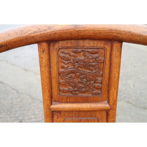 395 - A Chinese carved oak armchair with dragon head terminals and panel seat, 27