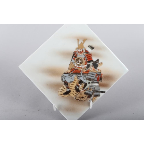 66 - A set of three Japanese hand-painted porcelain tiles with samurai figure decoration, largest 6 3/4