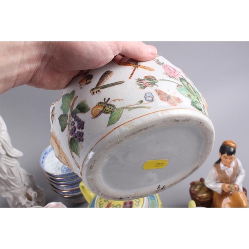 70 - A Chinese yellow polychrome decorated teapot and four matching teacups, a planter with insect and fl... 