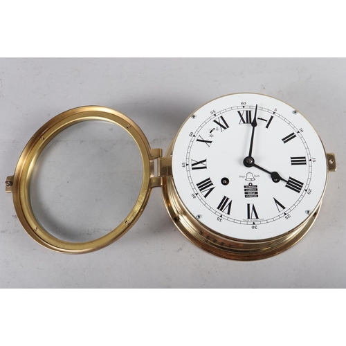 85 - A Sewills brass cased bulkhead clock with white enamel dial and Roman numerals, 7 1/4