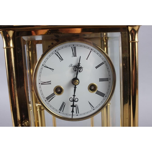 89 - A Rapport brass four-glass clock with white enamel dial and Roman numerals, 11 1/2