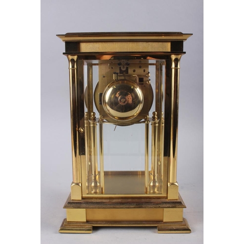 89 - A Rapport brass four-glass clock with white enamel dial and Roman numerals, 11 1/2