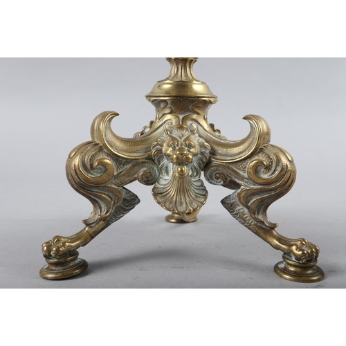 108 - A 19th century brass candlestick, now converted as a table lamp, on tripod and lion paw feet, 20 1/2... 