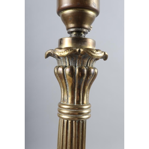 108 - A 19th century brass candlestick, now converted as a table lamp, on tripod and lion paw feet, 20 1/2... 