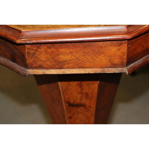 335 - A Victorian figured walnut octagonal top work table, on carved tripod splay supports with part fitte... 