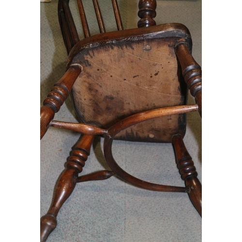 338 - An early 19th century ash and elm panel Windsor splat back elbow chair, on turned supports with crin... 