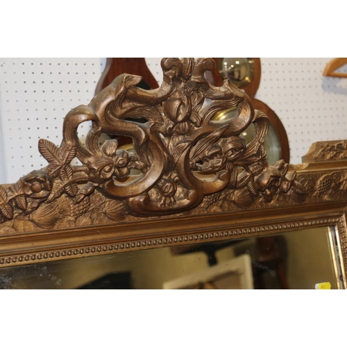 346 - A gilt framed wall mirror with pierced cresting, on moulded frame plate, 25 1/2