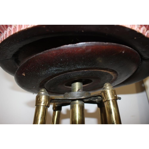 360 - An early 20th century brass framed piano stool with adjustable seat