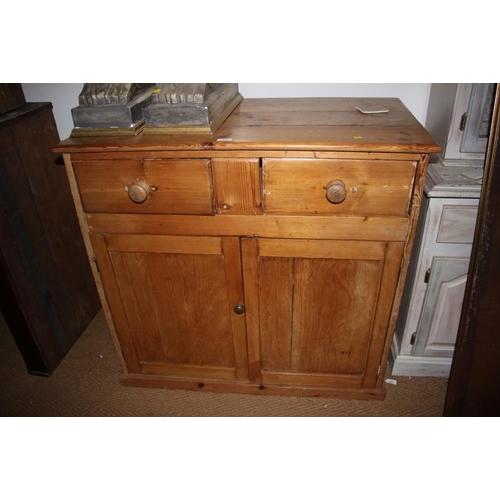 415 - A waxed pine side cabinet, fitted two drawers over two doors, on block base, 40 1/2