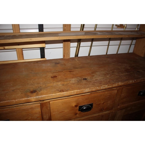 416 - A waxed pine dresser with open shelves over three drawers and three cupboards, on block base, 62