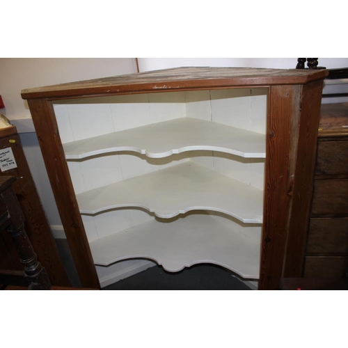 417 - A pine corner cabinet with open shelves over two doors, on block base, 51