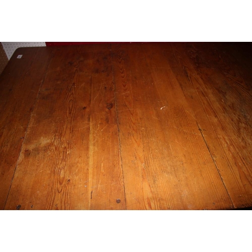 420 - A waxed pine kitchen table, on square taper supports, 71