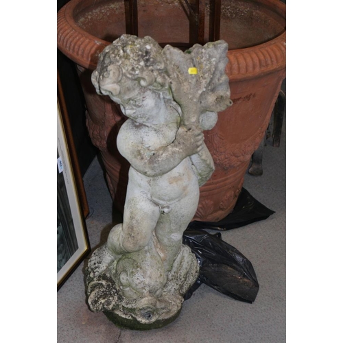 446 - A cast stone figure of putto with a leaf, 28