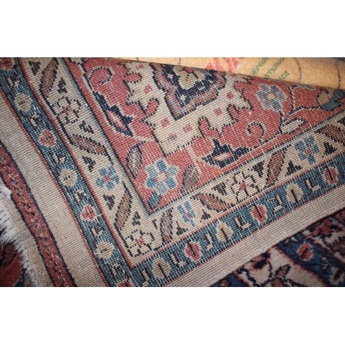 438 - A Persian design carpet with central floral medallion on a buff ground and multi-borders in shades o... 