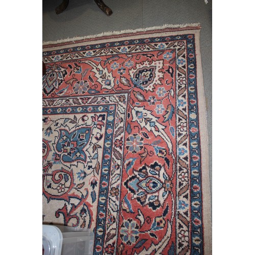 438 - A Persian design carpet with central floral medallion on a buff ground and multi-borders in shades o... 