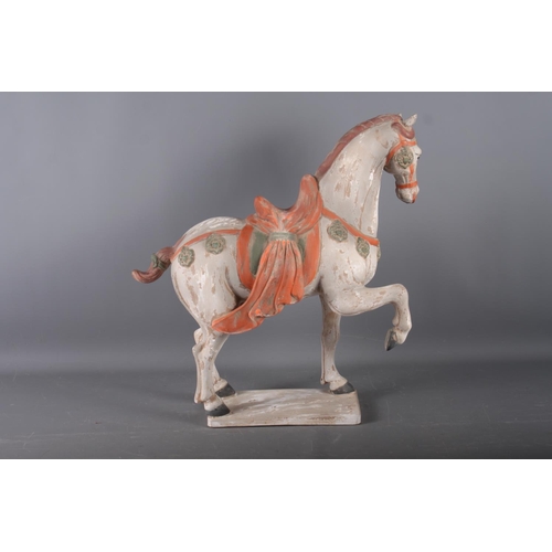 112 - A Tang style painted terracotta model of a horse, 20 1/4