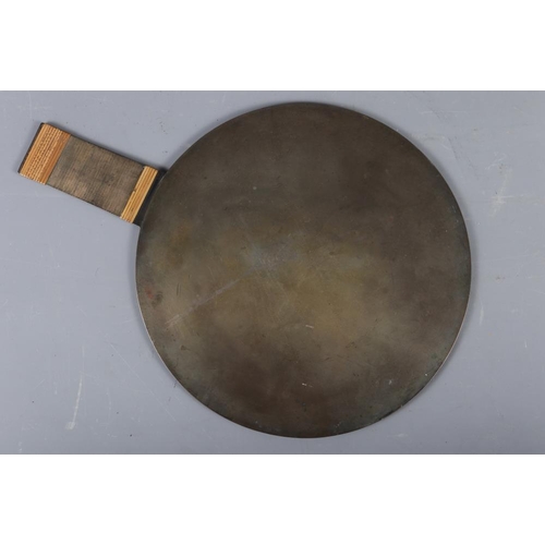 114 - A Japanese bronze circular hand mirror, decorated cranes in relief, 9 1/4