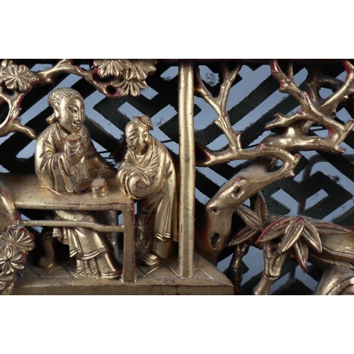 122 - A Chinese carved giltwood bed panel of a landscape with figures, 16 3/4