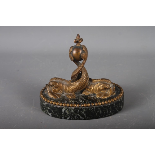 151 - A mid 19th century Continental bronze and marble oval desk weight, formed as two dolphins, 5 3/4