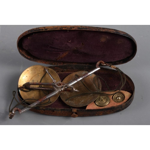 241 - A WWI compass in leather case, an apothecary's balance and weights, in wooden case, and a similar ba... 