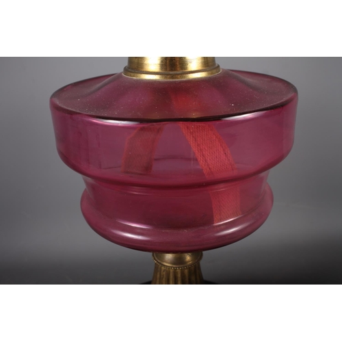 267 - A cranberry glass oil lamp with etched shade, 23 1/2